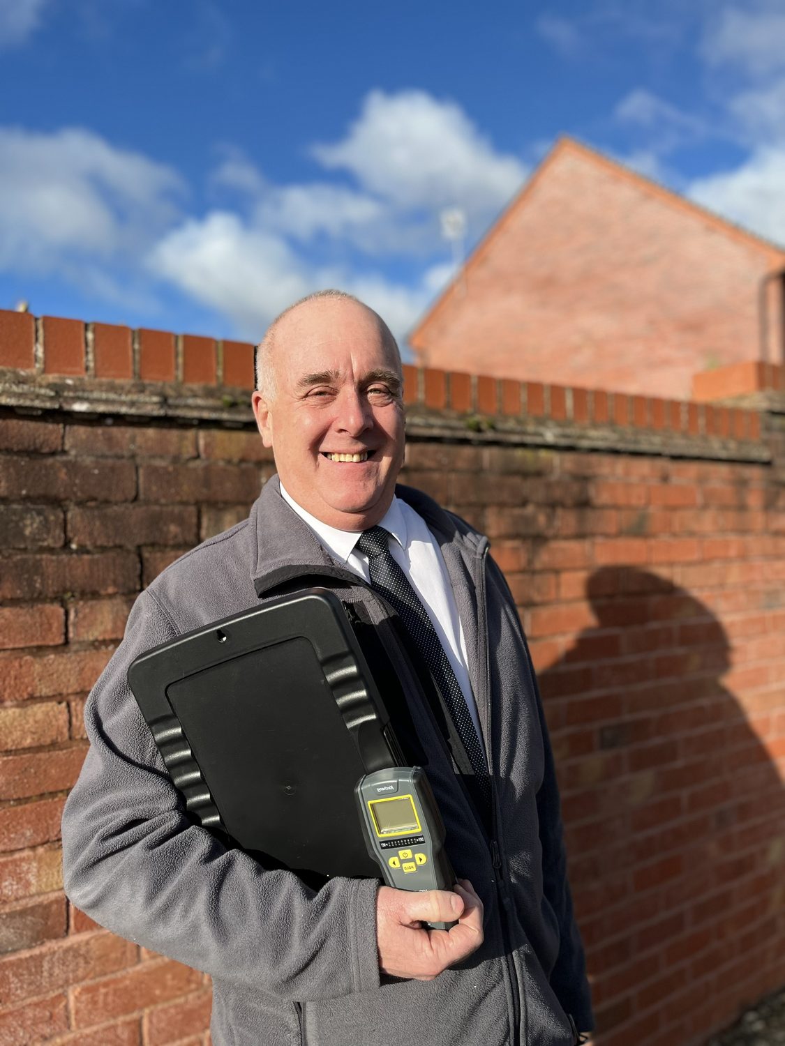 Stephen Thomas, founder of Thomas Damp Surveys, holding moisture detection equipment